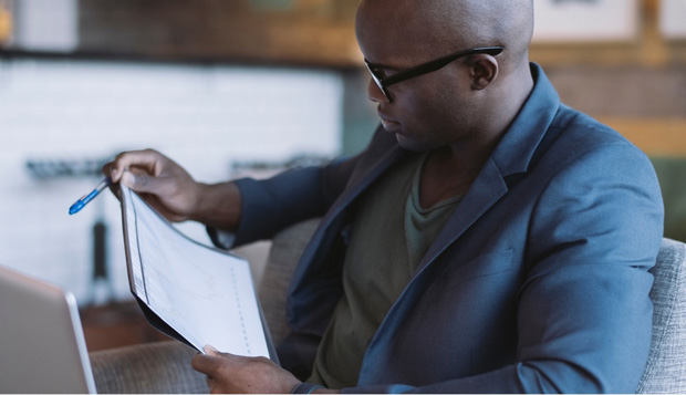 man looking at business papers at desk